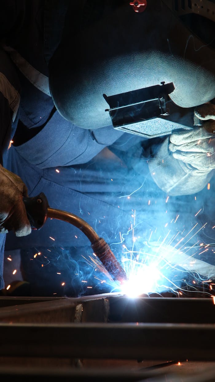 Intense welding process with sparks in an Istanbul industrial workshop, showcasing craftsmanship and safety.
